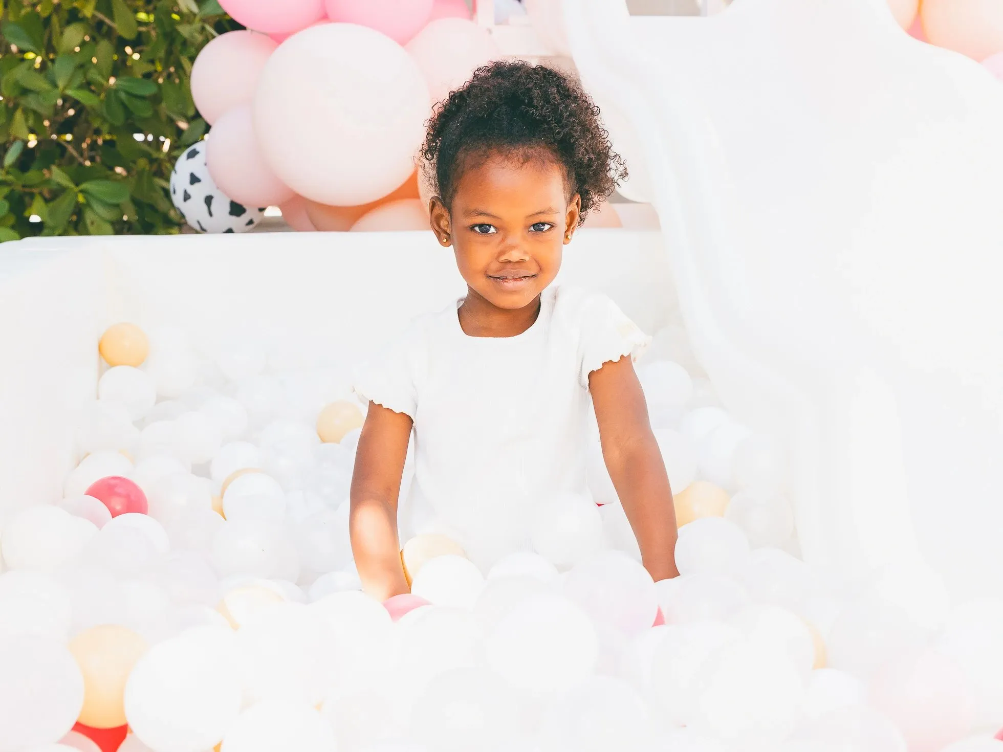 Girl in ball pit at Curl Freely event