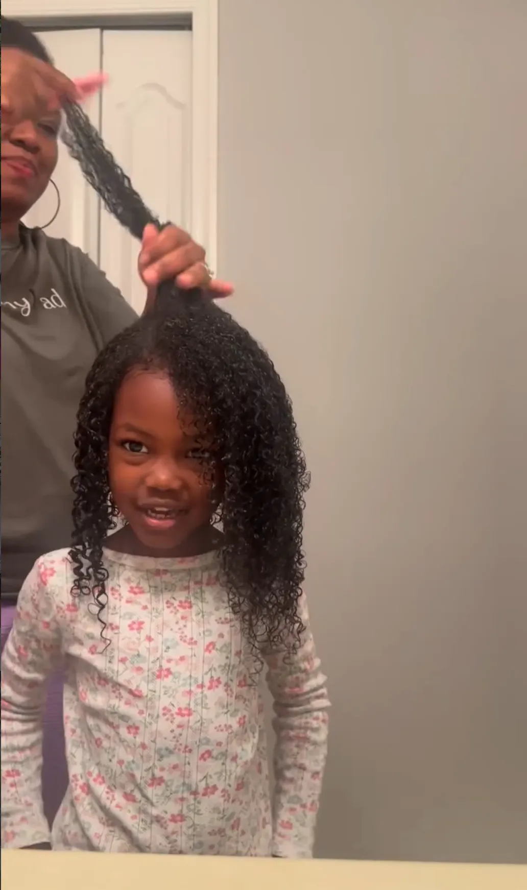 Young girl with natural curly hair styled with Curl Freely painfree hair beads and accessories